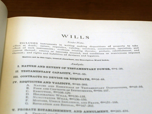 Open estate planning textbook on a table with the page titled wills